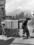 Boys Working in Pasta Factory Carry Rods of Pasta to Drying Rooms