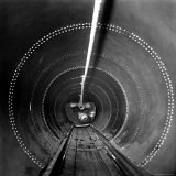 SAC's B-36 Bomber Flight Engineer Pulling Himself on Trolley from Plane's Rear Compartment to Nose