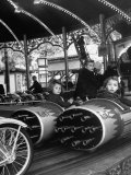 Children Waiting Expectantly For a "Rocket Ride" on the Carousel