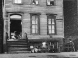 African American Children on Sidewalk in Front of a Tenement Building in the Slums of Chicago