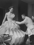 Buyer Sampling an Evening Dress on a Model to Check Its Quality