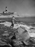 Man Fishing Off Montauk Point Montauk Lighthouse Visible in Background