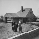 Truck Supervisor Bernard Levey Standing with Wife and Children in Front of Their Home