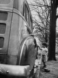 Happy Little Boy Assisting with Washing the Car