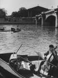 Man Playing Cello on Boat