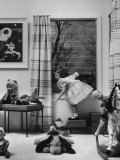 Little Girl Playing in Room Filled with Toys