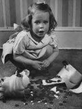 Little Girl Leaning over Her Broken Piggy Bank