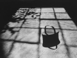 Handmade Covered Basket Sitting on Floor in a Sunlight Grid of Shadows at Shakertown Museum