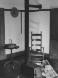 Iron Woodstove with a Ladder Backed Wooden Armchair in a Restored Shaker Parlor