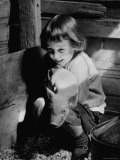 Jan Bruene with Piglet of a Group 2-3 Weeks Old  Kept in Basement of Home