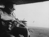 US Military Personnel Firing from Helicopters Onto Viet Cong Targets