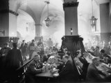 The Hofbrauhaus with Patrons Sitting at Long Tables Holding Large Steins of Beer