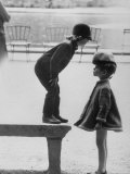 Little Boy Modeling a Two Piece Outfit by Pierre Cardin is Standing on Top of the Stoned Bench