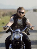 Member of Hell's Angels Riding Motorcycle on Road