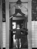 Denise Bruene Climbing Kitchen Door in Bare Feet  Her Hobby  Jan Bruene Says "Don't Fall on Me"