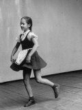 Little Girl Holding the Fringe of Her Skirt While Dancing Across the Floor