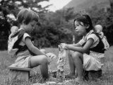 American Child Playing with Chinese Friend  Washing Doll Clothes