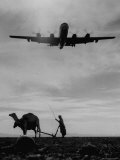 KC-97 Cargo Plane Returning from a Fuel Rendezvous  Landing over the Head of an Arabian Farmer