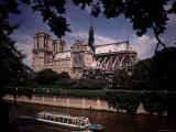 Notre Dame Cathedral as Seen from the Seine with Sightseeing Boat Going By