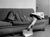 Writer Niven Busch Lying on Sofa with Newspaper over His Face as He Takes Nap from Screenwriting