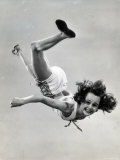 Natl Women's Tumbling Champion  15 Year Old  Bonnie Nebelong  in Mid Air with Legs Akimbo