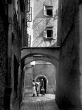 Three Young Women Chatting in Cobbled Alleyway of Old Section of Salzburg