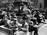 Woman Knitting Among Lunchtime Loungers Relaxing at Base of Statue at New York Public Library