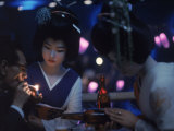Patron of Nightclub Uruwashi Having His Cigarette Lit by Geisha