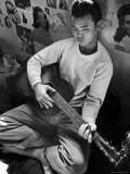 Young Japanese Nisei Playing Guitar in the Stockade at Tule Lake Segregation Center