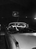 Young Couple Cuddling as They Watch a Movie at Drive in Theater