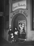 Salvation Army Workers Walking on Sidewalk and Carrying Papers