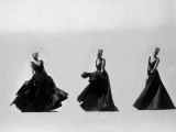 Triple Image of Model Demonstrating Swirling Motion of Black Taffeta Ball Gown Designed by Adrian