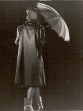 Model Wearing Hooded Raincoat  Boots and Carrying Umbrella
