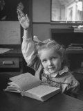 School Girl Raising Her Hand to Answer a Question
