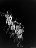 Stroboscopic Image of Woman Swinging Tennis Racquet as She Appears to Be Descending Staircase