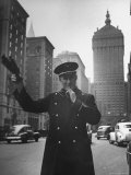 Park Avenue Doorman Using Whistle to Flag Down a Taxi For One of the Residents of His Building