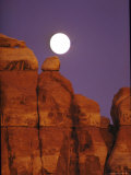 Moon over Orange Striated Rock Structures in Canyonlands National Park  Utah