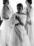 Three Models Wearing White Mink Stoles over Long Evening Dresses