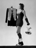 Model Wearing Wool and Nylon Skating Shorts and Vest and Carrying Figure Skates