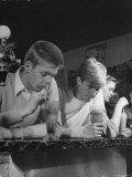 Teen Age Boys and Girls Drinking Milkshakes in Drug Store
