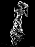 Model Swinging in a Dance Step to Show Off Satin Evening Dress