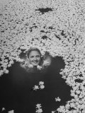 Young Girl Swimming in Pool Covered with Gardenia Blossoms