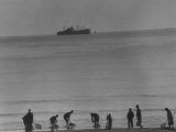 Silhouettes of Chinese Men and Women Digging Clams on Beach