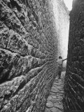 Young Man Standing in a Narrow Passageway of the Valley Ruins
