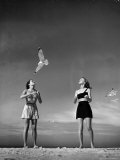 Models Tee Matthews and Bobbie Chambliss Feeding Gulls While Modeling New Bathing Suit Styles
