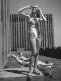 Model Wearing Sunglasses and Swim Suit Sunbathing on Roof of Rockefeller Center