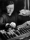 Russian Woman Using an Abacus to Calculate Numbers in Business