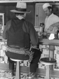 Movie Cowboy Sitting at Soda Fountain Counter During Break in Shooting