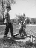 Two Boys Getting Water from a Pump at Rural School