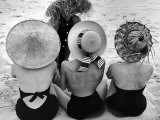 Models on Beach Wearing Different Designs of Straw Hats